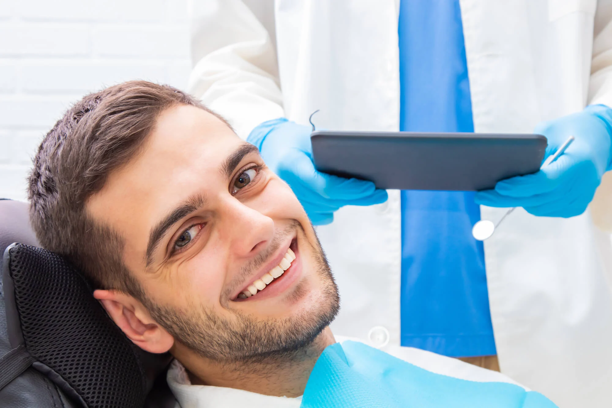 dental patient smiles after getting dental implants in montgomery .jpg