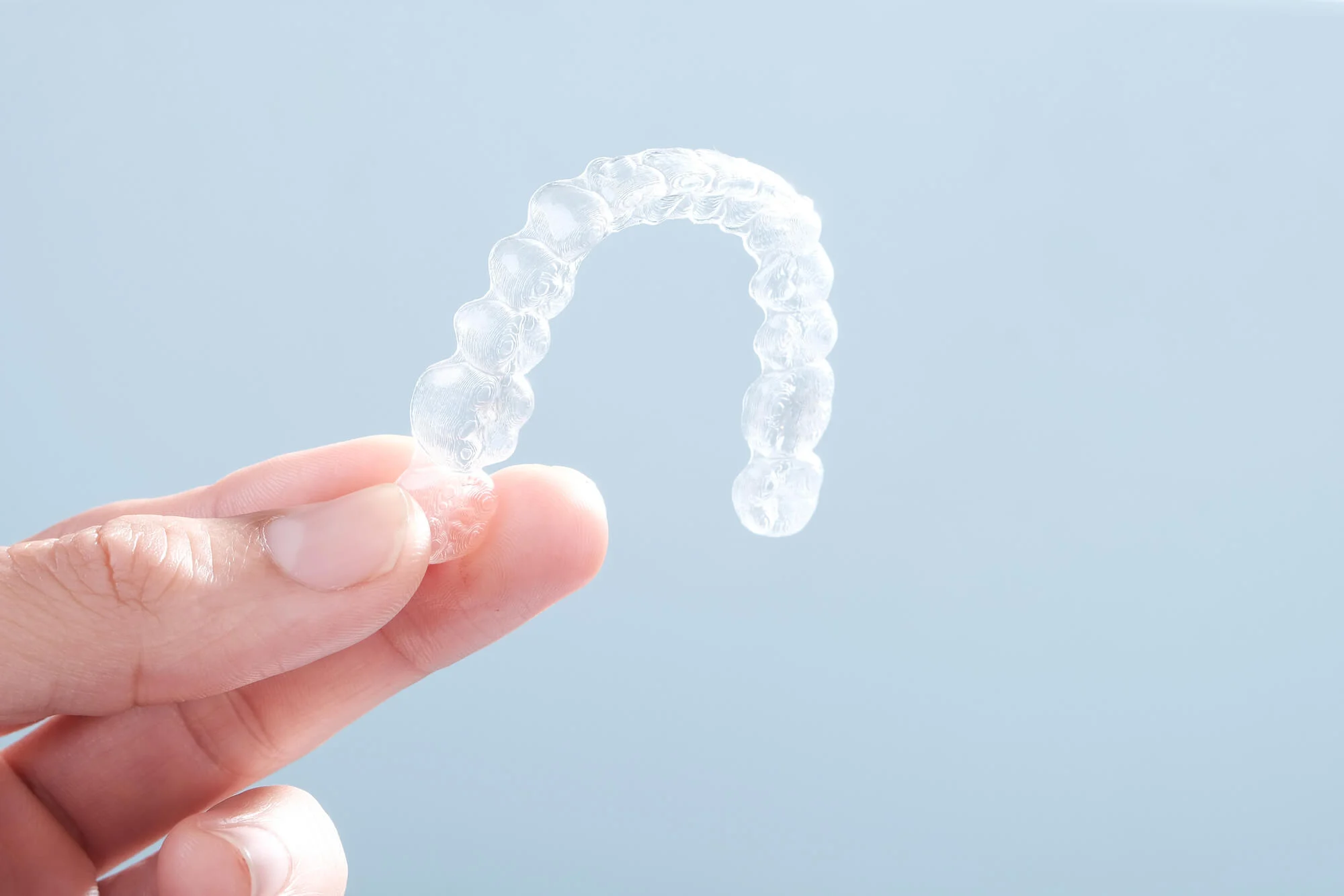 patient holding and choosing clear aligners over braces montgomery alabama 