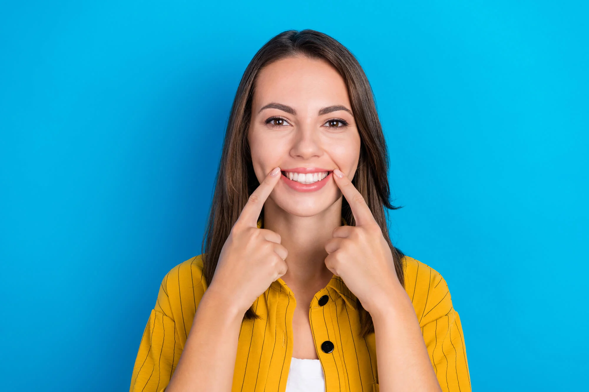 woman proudly wearing all on four dental implants