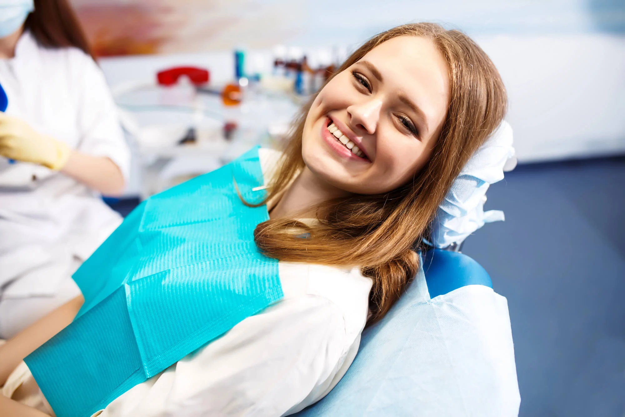 woman smiling during appointment with dentists that do root canals near me