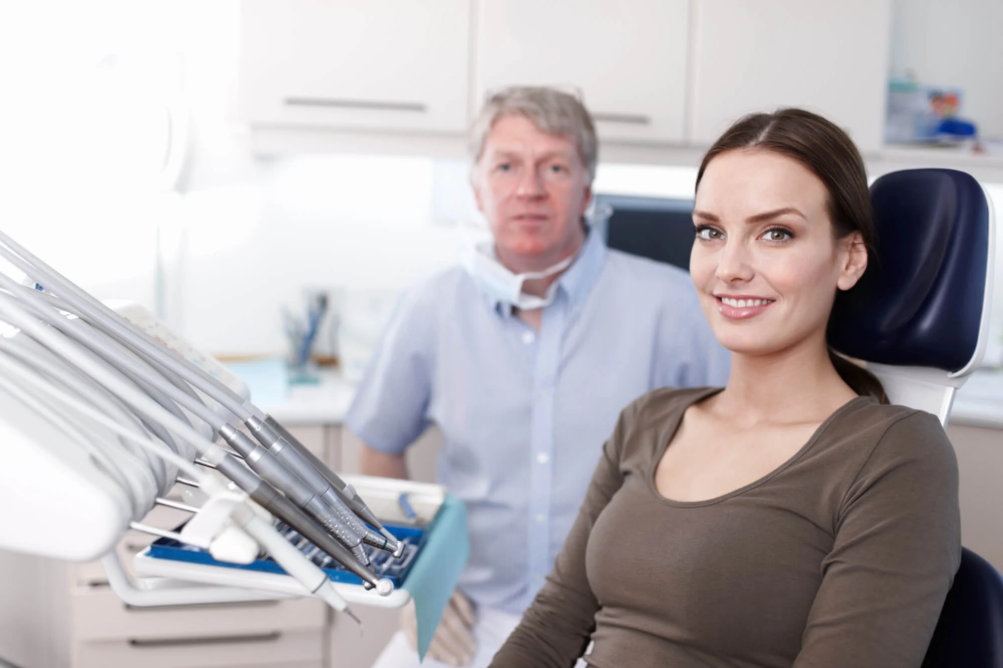 woman discussing tooth extraction cost Alabama with dentist