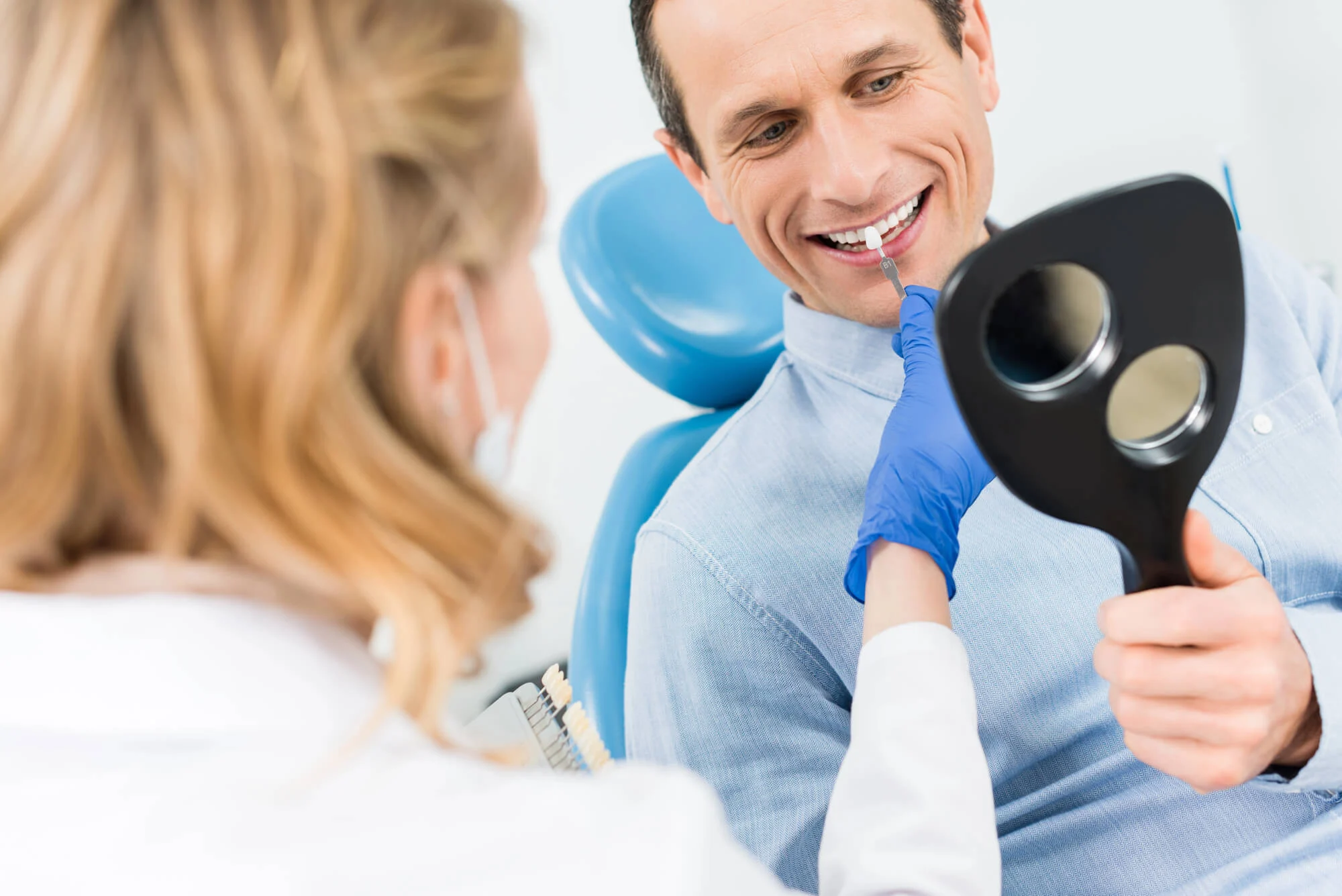 patient happily looking at his dental implants in montgomery al