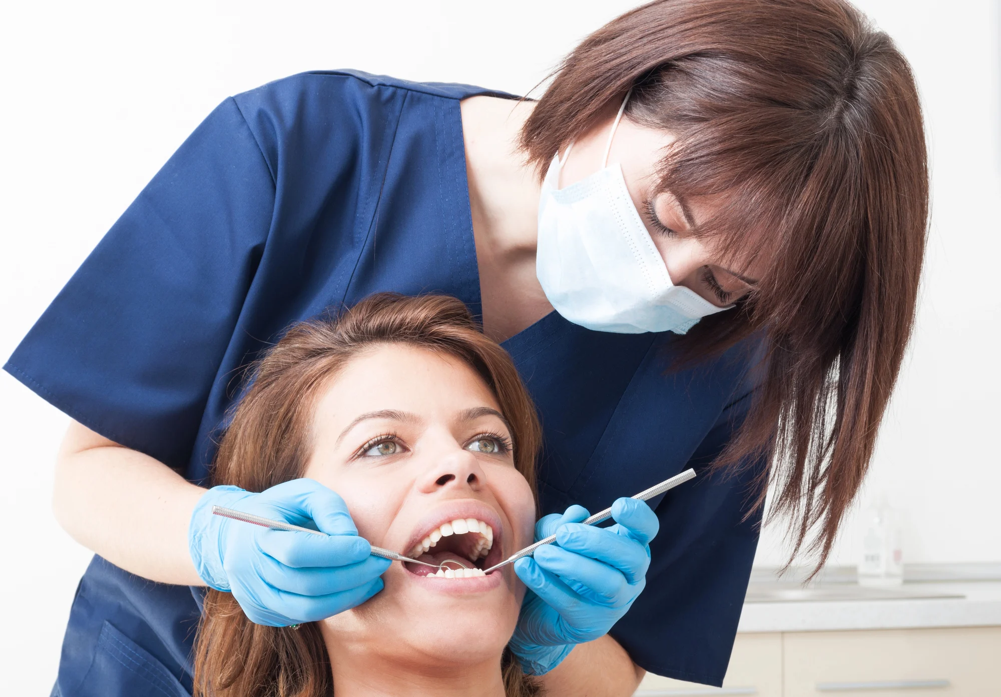Woman being checked for tooth extraction cost alabama