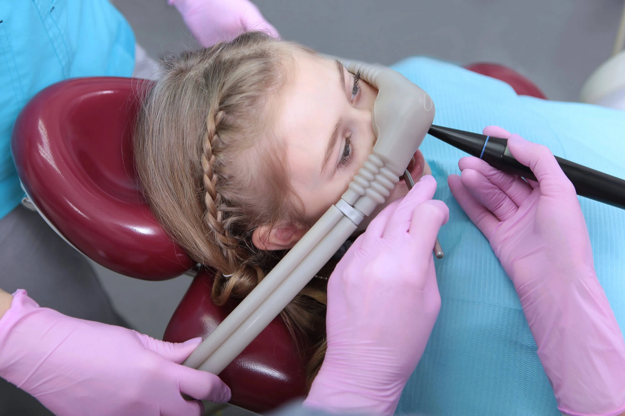 Girl wearing mask instructed by nitrous oxide dentist